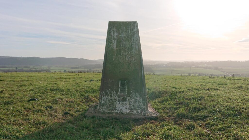 Front of the Dinedor Hill Trig Point