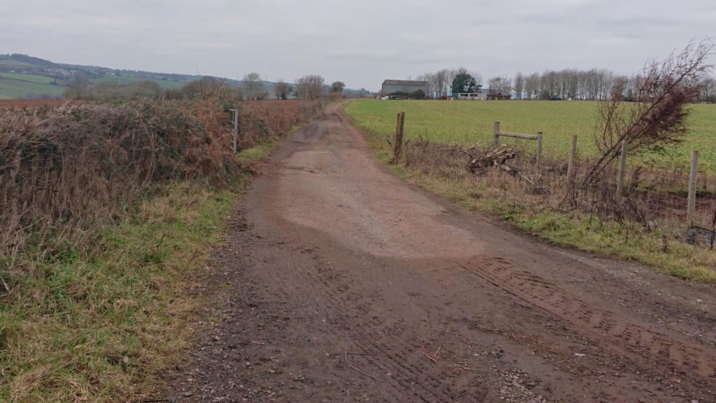 Muddy track up to farm buidlings