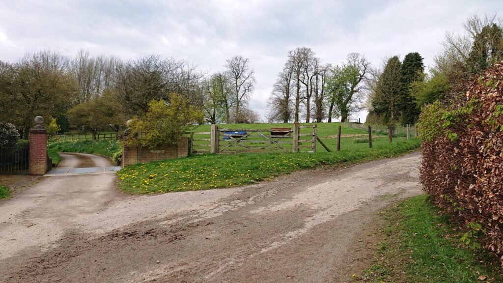 Road splits either side of a gate